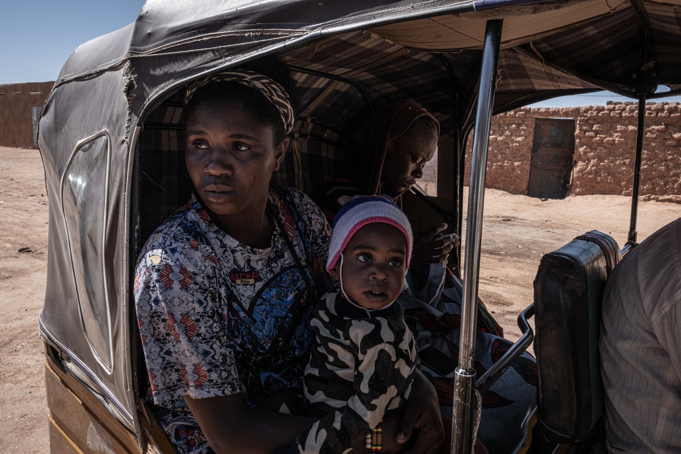 Pita, 35 ans, a quitté le Nigeria il y a des années. Elle est à bord d'un {tuk-tuk} pour aller chercher un emploi en ville.