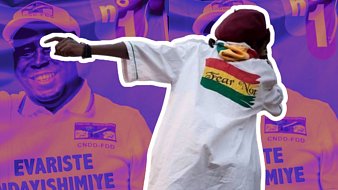 L'image présente une scène dynamique où une personne en mouvement semble célébrer ou exprimer de l'enthousiasme. Elle porte une grande chemise blanche drapée avec une inscription colorée à l'arrière, qui représente un drapeau. En arrière-plan, deux silhouettes floues d'un homme souriant entrecroisent des motifs aux couleurs vives, suggérant un événement festif ou politique. Les teintes dominantes sont violettes et jaunes, créant une atmosphère vibrante. L'ensemble transmet des émotions positives et une dynamique de joie.