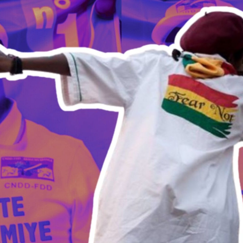 L'image présente une scène dynamique où une personne en mouvement semble célébrer ou exprimer de l'enthousiasme. Elle porte une grande chemise blanche drapée avec une inscription colorée à l'arrière, qui représente un drapeau. En arrière-plan, deux silhouettes floues d'un homme souriant entrecroisent des motifs aux couleurs vives, suggérant un événement festif ou politique. Les teintes dominantes sont violettes et jaunes, créant une atmosphère vibrante. L'ensemble transmet des émotions positives et une dynamique de joie.